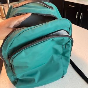 Beautiful green AWAY backpack with lots of pockets. M monogram on side.